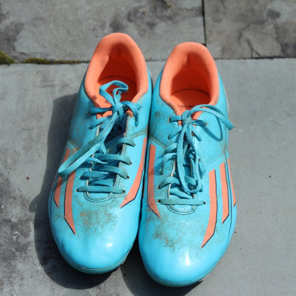 Blue and orange soccer cleats